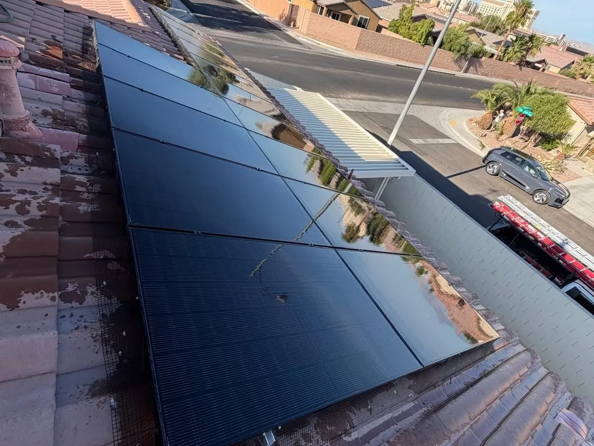 The same solar array rinsed and dry, the glass reflecting the sky